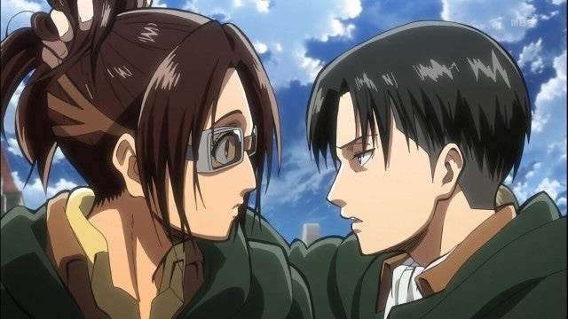 attack on titan review, levi and hange face each other closely while sharing a serious and tense conversation