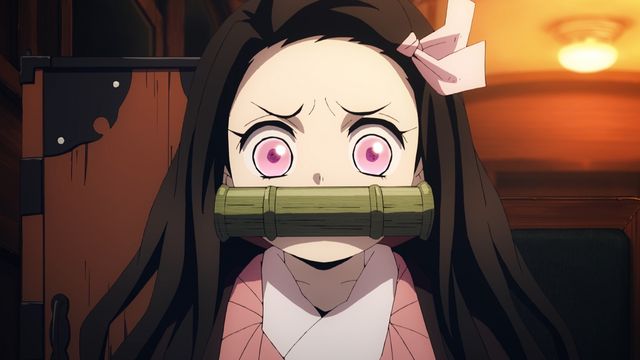 kimetsu no yaiba review, nezuko kamado staring wide-eyed with a bamboo muzzle in a close-up indoors