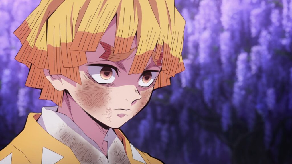 demon slayer: kimetsu no yaiba review, zenitsu agatsuma looking tired and worried in a close-up with wisteria flowers behind him